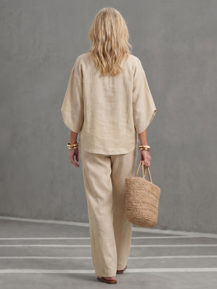 Femme portant un ensemble deux pièces avec tunique boutonnée et pantalon droit, coloris beige
