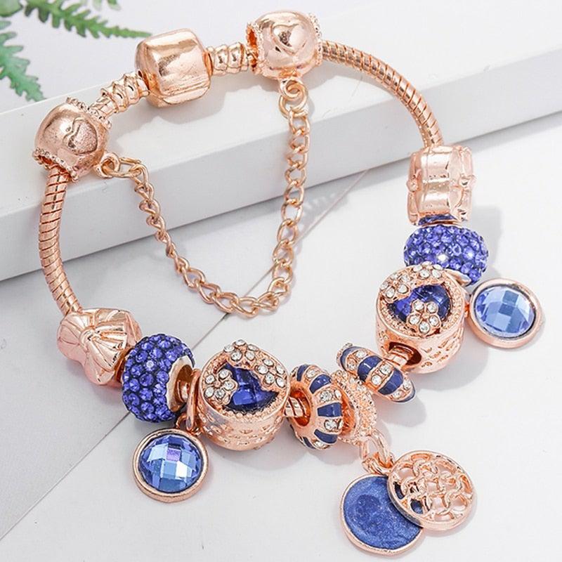 Ton Bleu | Bracelet à breloques or rose avec perles bleues – Vue 01